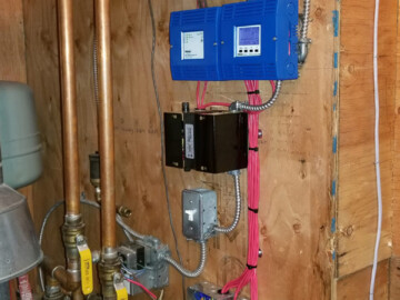 Tekmar control system added to an existing air to water heat pump with a gas backup heating radiant floors